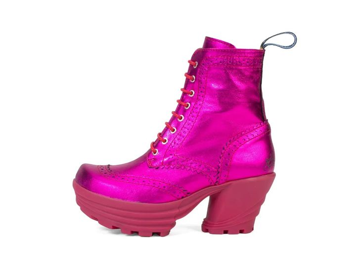 a shiny magenta leather boot with a platform heel is displayed on a white background. the boot has pink laces, a decorative perforated pattern around the edges, and a loop at the back of the ankle.