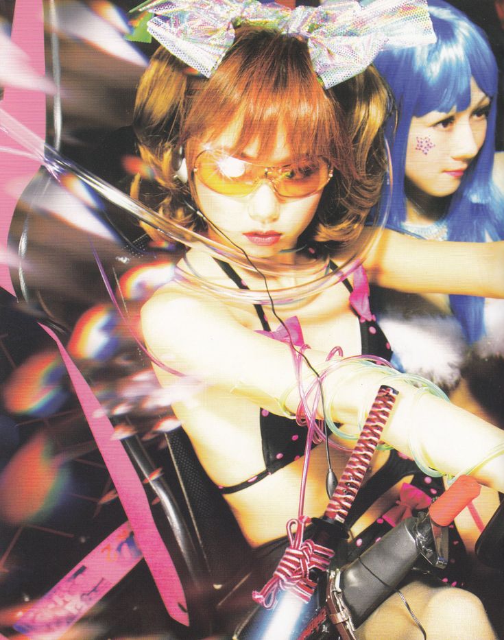 two japanese women in a cyberpunkinspired setting. the woman in the foreground is wearing a black polka dot bikini top, yellow sunglasses, and a large holographic bow in her hair. she has a serious expression on her face.  she is holding a large, futuristiclooking weapon. the woman in the background is wearing a white furry top and has bright blue hair. she is looking off to the side and has a more neutral expression on her face. the background is a blur of pink and purple lights.