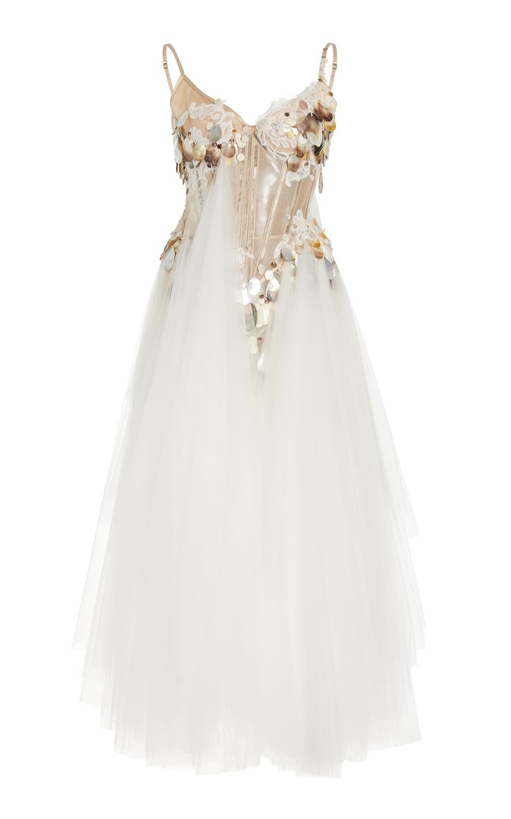 a white tulle gown with a beaded and lace corset top. the dress is sleeveless and features a sheer bodice adorned with delicate floral appliques. the skirt is full and flowing with multiple layers of tulle.  this dress is perfect for a formal occasion like a wedding or prom.