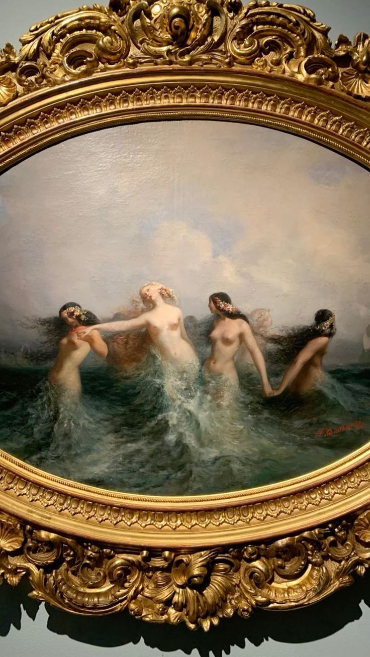 an oil painting of five nude women in the ocean, their bodies intertwined as if in a dance or embrace. the women, with flowing hair adorned with flowers, appear to be mermaids or water nymphs, their lower bodies submerged beneath the waves. the scene is set against a backdrop of a cloudy sky and churning water. the painting is housed in an ornate gold frame, which enhances the artwork's classical and romantic aesthetic.