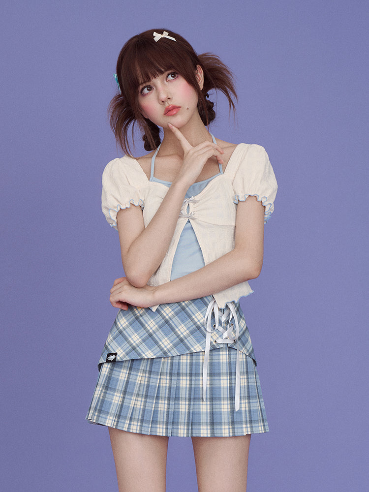 a young asian girl is posing in a studio against a solid purple background. she's wearing a light creamcolored puffsleeve top over a light blue halter top, and a pleated light blue and white plaid skirt with laces at the front. she has her hair styled in pigtails with small bow hair clips, bangs, and is looking up thoughtfully with her hand on her chin.  the overall style is sweet and innocent with pastel colors and cute details.