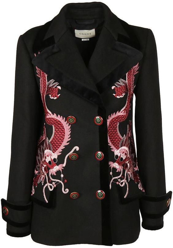 a black, doublebreasted jacket with intricate red and pink dragon embroidery on the front panels. the jacket features velvet trim along the collar, lapels, and cuffs. it has button closures down the front and a gucci label is visible inside the collar. the jacket is photographed against a plain background.