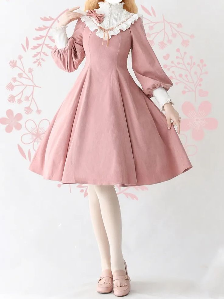 the image showcases a woman modeling a charming pink lolita fashion dress. the dress features long, puffy sleeves, a ruffled collar and neckline, and a flowing aline skirt that falls above the knee. it's paired with white tights and brown mary jane shoes. the studio lighting illuminates the details and soft pink hues of the dress, creating a delicate and feminine aesthetic.