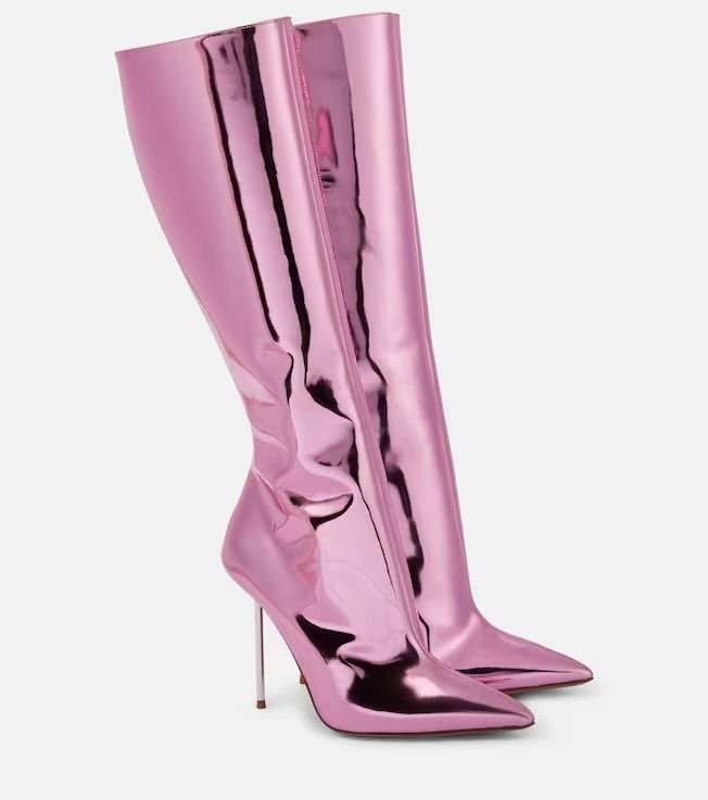 the image shows a pair of kneehigh boots in a metallic pink color. the boots have a pointed toe and a stiletto heel. the material appears shiny and reflective. they are set against a plain white background.