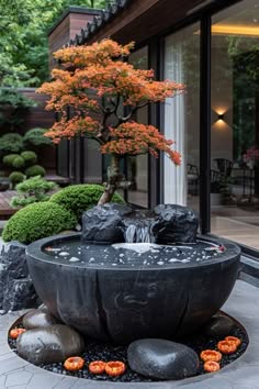 a serene and peaceful japanese garden with a stone pond and fountain. the pond is surrounded by smooth, grey rocks and lush greenery. a small, elegant japanese maple tree stands tall in the background, providing shade and a touch of color. the scene exudes tranquility and relaxation, inviting visitors to unwind and enjoy the beauty of nature.