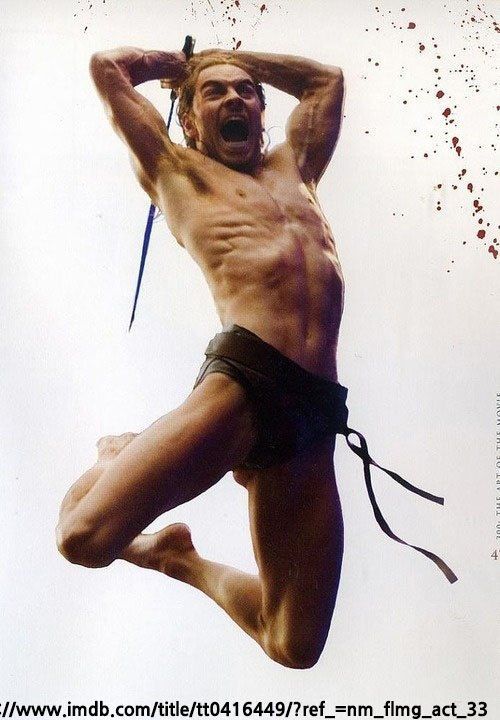 a photo of a shirtless muscular man with a sword in his hand jumping and screaming. there is a blood splatter effect on the background. he is wearing a pair of black shorts. the man is posing for an action movie poster.
