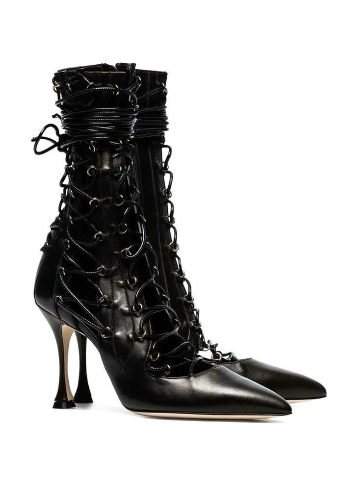 a pair of black leather women's boots with stiletto heels are shown in the image. the boots are laceup style with cutouts and pointed toes. they appear to be made of highquality leather and are styled elegantly.  the background is plain white, emphasizing the boots.