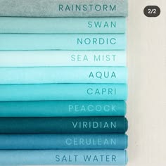 a stack of felt fabric swatches in different shades of blue, teal and green.  the felt fabric is arranged from lightest to darkest, with the lightest shade of blue at the top and the darkest shade of green at the bottom. the colors are labeled with their names, which include: rainstorm, swan, nordic, sea mist, aqua, capri, peacock, viridian, cerulean, salt water.