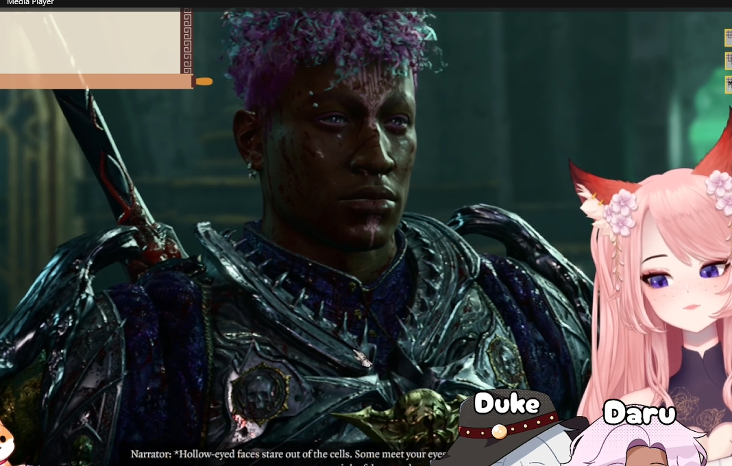 the image is a screenshot of a video game live stream. it shows a closeup of a darkskinned male character with white and purple hair, wearing ornate armor. he appears to be inside a dimly lit prison cell. on the right side of the image, two animestyle digital avatars (a man in a cowboy hat and a pinkhaired woman with fox ears) are superimposed, suggesting they are reacting to the game. the game's narrator describes the scene with the text: "holloweyed faces stare out of the cells. some meet your eyes". the overall atmosphere is dark and mysterious.