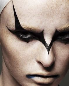 close up portrait of a woman with dramatic black eyeliner and dark eye makeup.