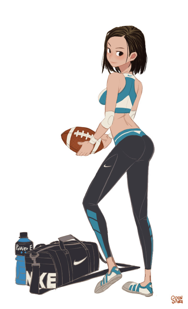 a young woman in workout attire stands with a football in her hand. she's wearing a teal sports bra and black leggings with teal accents, along with wristbands and white sneakers. a gym bag and a bottle of powerade are on the floor beside her. she has an athletic build and a confident expression.