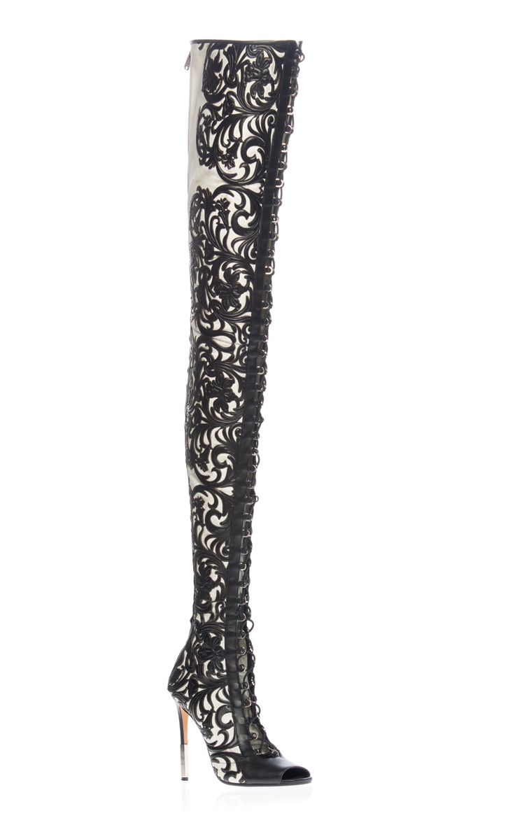 a pair of black and white floral lace thigh high stiletto heeled boots. the boots are made from a soft, supple leather that is both stylish and comfortable. the floral lace design is intricate and eyecatching, while the stiletto heel adds a touch of elegance. the boots are perfect for a night out on the town or a special occasion.  the boots are a beautiful example of high fashion, and are sure to turn heads wherever you go.