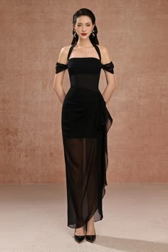 a beautiful woman is posing in a black, long, formal dress