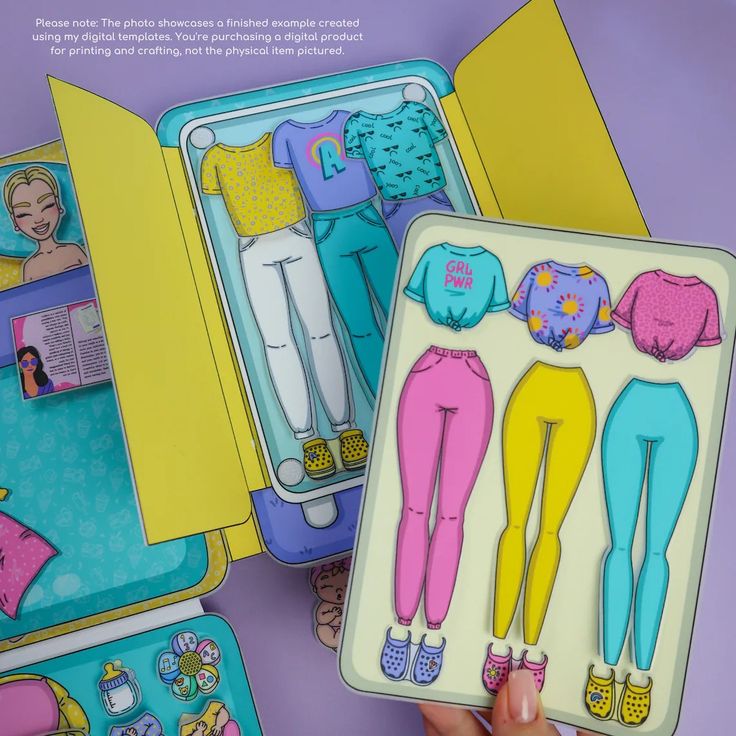 the image showcases a paper doll set with various outfits and accessories. the doll and clothing items appear to be printed on paper and cut out for crafting. the set includes multiple tops, bottoms, and shoes in different colors and styles, along with accessories like a baby bottle and pacifier.