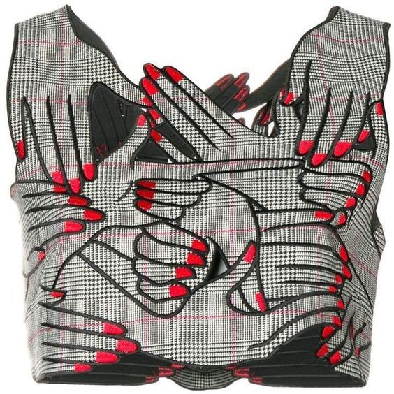 a plaid crop top with a design featuring many overlapping hands with red nail polish. the hands are outlined in black and create a bold, artistic pattern on the garment. the top has black trim around the edges.