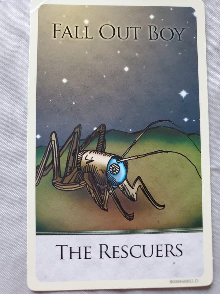 this is the album art for fall out boy's album "the rescuers." it features a stylized, mechanical, futuristiclooking insect with blue glowing eyes. the image is set against a backdrop of a night sky with stars. the band's name and the album title are both written in bold, white text at the top and bottom of the image. the image appears to be on a card or collectible.