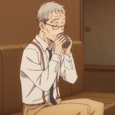 an older man with white hair and glasses sits on a tan couch while drinking from a brown mug. he is wearing a white dress shirt, red suspenders, and brown pants. he appears to be lost in thought. the image has a warm and inviting atmosphere.