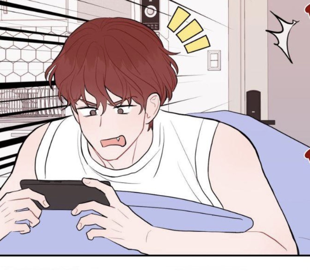 the image is a panel from a manhwa (korean comic) or webtoon. it depicts a young man with short, reddishbrown hair lying in bed, looking surprised or startled while holding and looking at a phone. he's wearing a white tank top and is partially covered by a light purple blanket. the art style is clean and modern, with soft lines and pastel colors. the background shows a glimpse of a kitchen or bathroom. there are also speech bubbles suggesting excitement or surprise. the overall mood is light and casual.