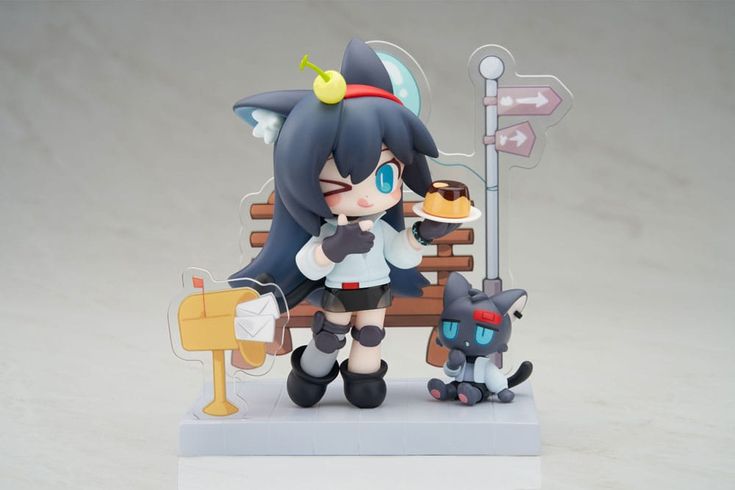 closeup shot of a collectible anime figurine, showcasing a chibistyle girl character with cat ears and a black hooded top. she's holding a pudding and sitting on a park bench, accompanied by a small black cat. a mailbox and a street sign are also included in the miniature diorama setting. the figurine is highly detailed and features vibrant colors.