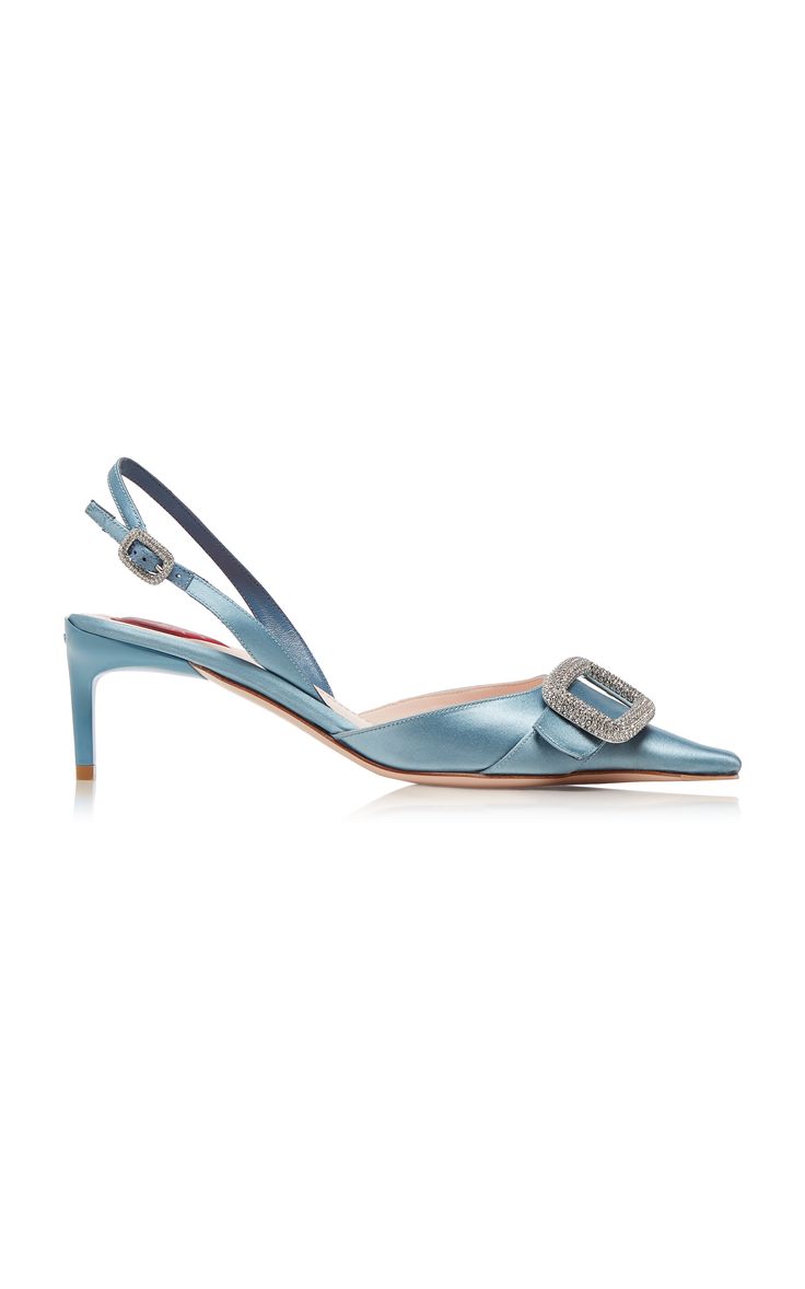 a pair of light blue satin slingback pumps with a pointed toe and a crystal buckle. the heels are about 3 inches tall. the shoes are elegant and formal, perfect for a special occasion.