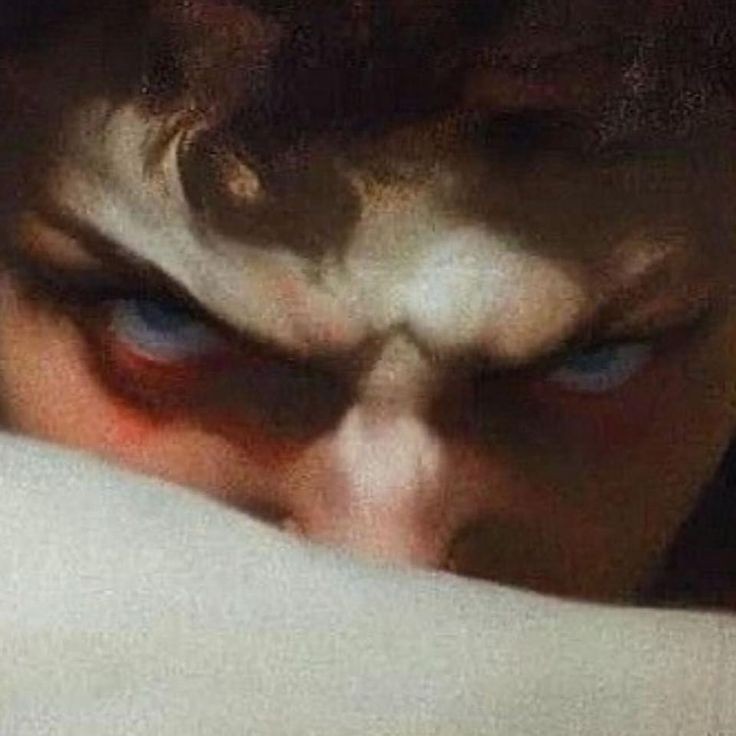 the image is a closeup of a man's face contorted in anger. his eyes are wide and bloodshot, and his brow is furrowed. the lighting is dramatic, with deep shadows emphasizing the man's features. the overall effect is one of intense emotion.