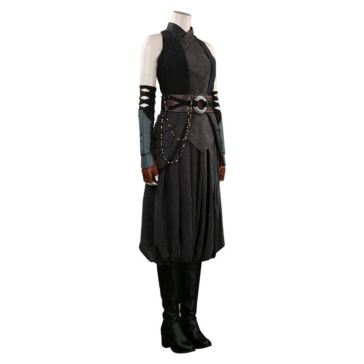 a female cosplayer is wearing a black and grey costume with black boots and a decorative belt. she is standing in a full body pose.