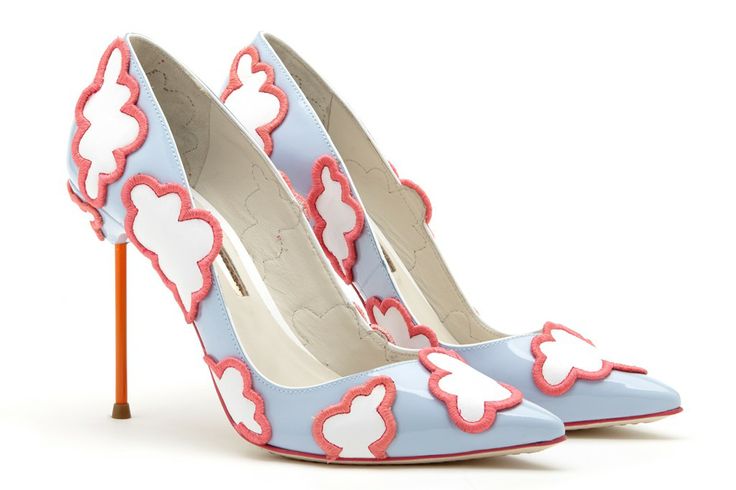two blue high heels with white cloud designs outlined in pink are displayed on a white background. the heels are orange.