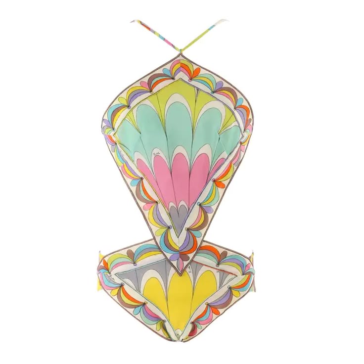 a colorful onepiece swimsuit with an abstract geometric pattern is displayed against a plain white background. the swimsuit has a halter top style with thin straps and a cutout design at the waist. the pattern features a mix of vibrant colors including yellow, pink, blue, and orange, arranged in a retroinspired design.