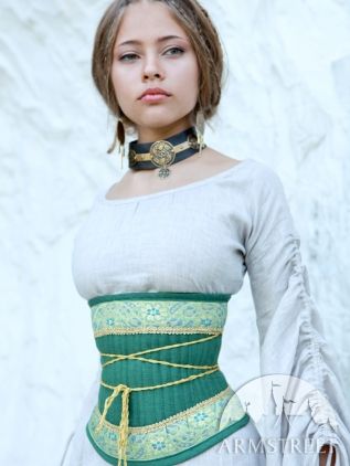 a young woman, possibly a model, is shown wearing a medievalstyle or renaissancestyle outfit.  she has light brown hair and is wearing a light beige or offwhite linen dress with puffed sleeves.  the main focus is a tealcolored corset or bodice with gold and light green trim and detailing.  the corset is laced up the front with a light tan or beige cord. she is also wearing a dark choker necklace with gold accents. the background is a plain white textured surface. the photo appears to be a studio shot, possibly for a clothing catalog or historical reenactment group. the watermark "armstreet" suggests the clothing may be from that company.