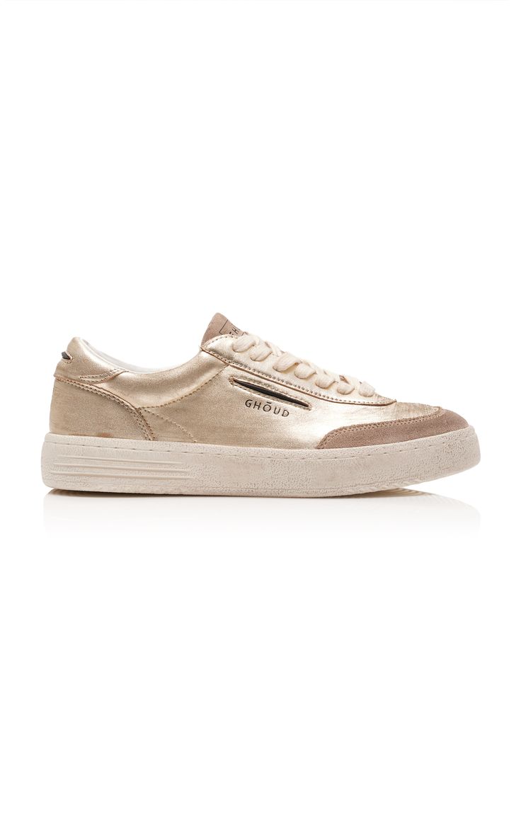 a pair of ghoud gold leather lowtop sneakers are shown in a side profile view against a white background. the sneakers have a creamcolored sole and the ghoud branding is visible on the side.