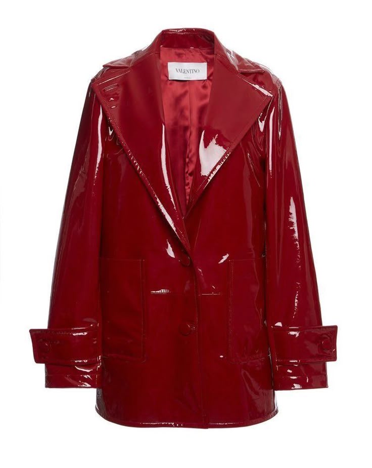 a valentino red patent leather coat is presented on a white background. the jacket has a glossy, reflective finish and a structured collar. the coat is singlebreasted with two visible buttons. two square pockets are positioned on the lower front of the coat. the sleeves have buttoned cuffs. the interior lining can be seen in the open collar. a tag that says "valentino" is visible on the inside of the collar.
