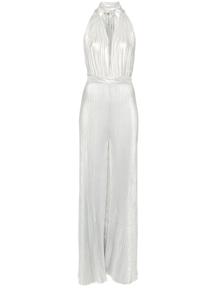 a silver halter jumpsuit with pleats. the jumpsuit is sleeveless and has a deep vneckline. the fabric is metallic and has a slight sheen. the jumpsuit is fitted through the bodice and flares out from the hips. it is a sophisticated and elegant piece that would be perfect for a formal event.