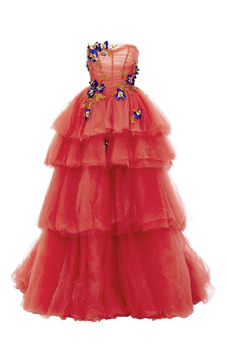 a coralcolored, strapless, tiered tulle ball gown embellished with blue and gold floral details on a white background.