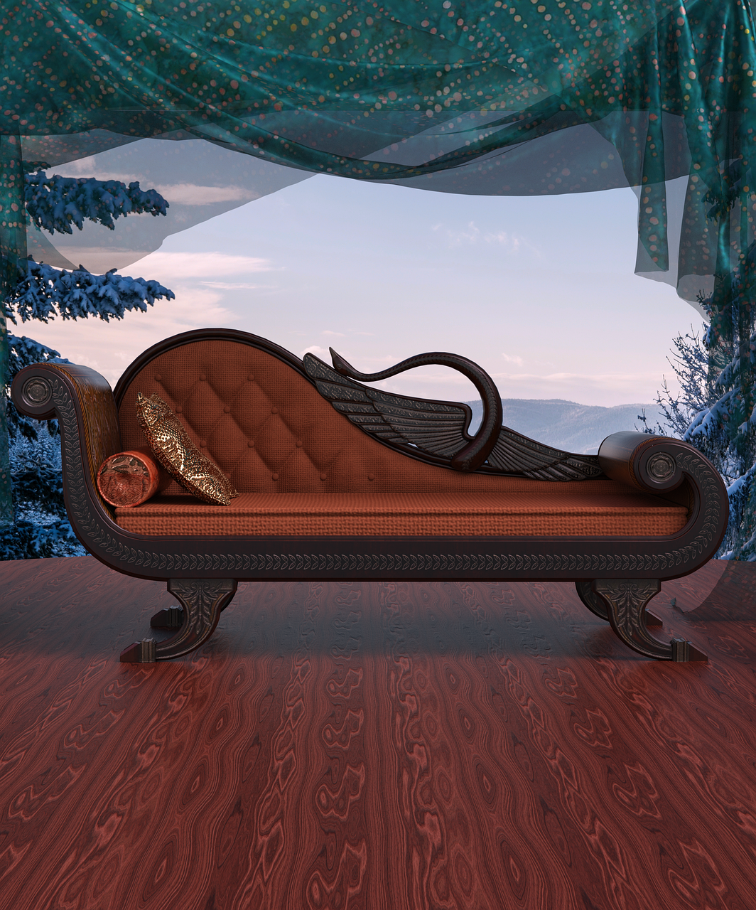 a chaise lounge sits on a wooden floor in front of a window. the window shows a winter scene with mountains and trees. a curtain hangs above the window. the chaise lounge has pillows on it.