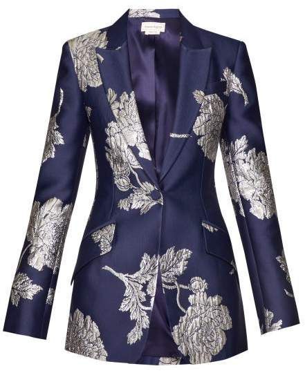 a navy blue blazer with a silver floral pattern is displayed. the blazer is fitted and has a singlebutton closure. the lining is a darker shade of blue.