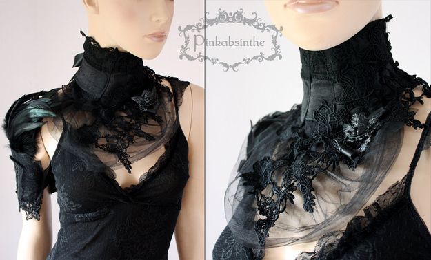 a woman is wearing a black lace choker that is very intricate. the choker is made of black lace and has a large black feather accent. she is wearing a black dress with a black lace overlay. the model is wearing a black lace choker, a black dress, and has a very dramatic look to her. she is looking very elegant and stylish in her outfit.