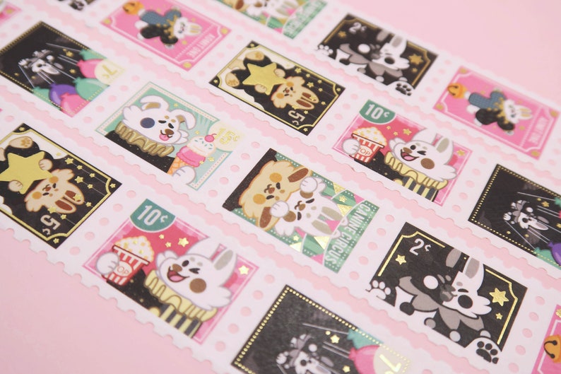 closeup shot of adorable washi tape featuring a series of illustrated stickers. each sticker is designed like a vintage postage stamp with a scalloped border. the stickers showcase cute cartoon animals, primarily rabbits and dogs, participating in circusthemed activities. some are enjoying popcorn and ice cream, while others are performing in the circus ring.  the color palette is predominantly pink and black with gold foil accents, creating a whimsical and kawaii aesthetic. the stickers are arranged in a repeating pattern on a pink background, demonstrating the washi tape's decorative quality.