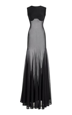a black, sheer sleeveless gown with a long skirt. the gown is fitted to the body and has a sweetheart neckline. it is a formal dress that would be suitable for a party or other special event. the model is wearing the dress and posing in front of a white background.