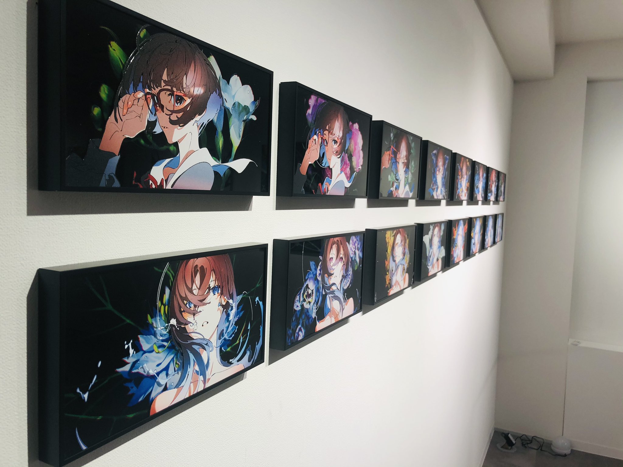 a gallery wall featuring a series of framed anime artworks. each piece depicts the same female character with slight variations in pose and color palette. the art style is vibrant and modern, characterized by bold lines and a mix of abstract and realistic elements. the gallery space is bright and minimalist, allowing the artwork to take center stage.