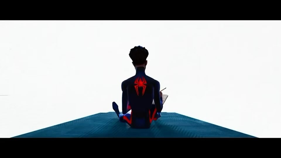 the image is a still from the animated film "spiderman: into the spiderverse." it shows miles morales, the main character, sitting with his back to the viewer. he is sketching or drawing in a sketchbook. his spiderman suit is visible from behind, particularly the red glowing spider symbol on his back. the background is a simple, minimalist white and a dark teal surface miles is sitting on. the overall style is dark, dramatic, and artistically stylized, capturing the aesthetic of the film.