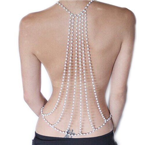 image of a woman from the back wearing a pearl body chain that starts around her neck and drapes down her back in several strands, connecting at the lower back. she has a tattoo on her lower back.