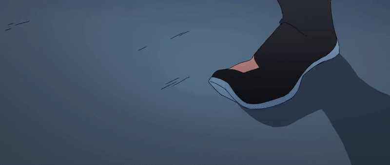 a blue sole of a black shoe is seen walking along a flat surface.  the ground is grey and the shoe leaves behind a shadow.