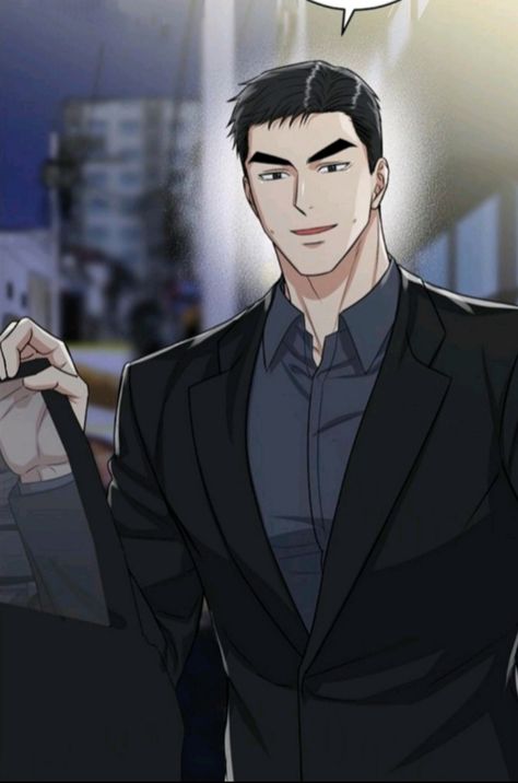 the image shows a man wearing a suit and tie. he is standing and smiling. the background is dark and blurry, suggesting an indoor setting with artificial lighting. the man's suit is black and he has a grey shirt on underneath. he has dark hair and a strong jawline. he appears to be holding a black bag in his left hand.  the image is a closeup, focusing on the man's upper body.