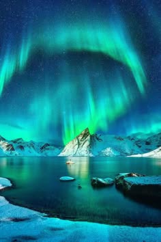 a breathtaking view of the aurora borealis reflecting in a still lake. the vibrant green lights dance across the night sky, illuminating the snowcapped mountains that rise from the water. the scene is one of aweinspiring beauty and tranquility.