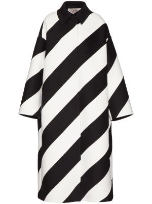 a long, collared coat with bold black and white diagonal stripes. the coat is closed in the front, has long sleeves, and is likely intended for women's fashion.
