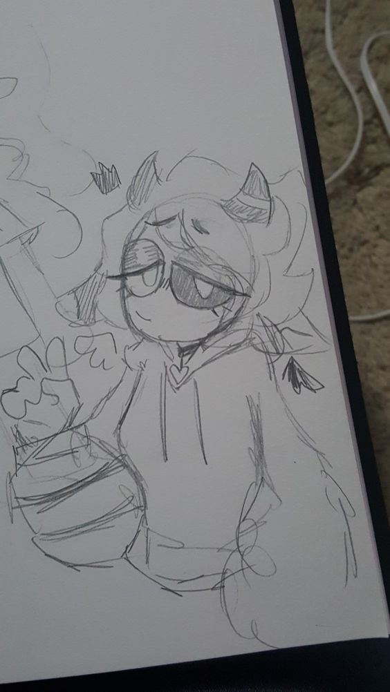 it is a black and white, pencil sketch of a person with horns wearing a hoodie. they are waving with their left hand. the drawing is on white paper and takes up twothirds of the page. there is a black binder clip visible to the right of the drawing, and white string/cable in the background.