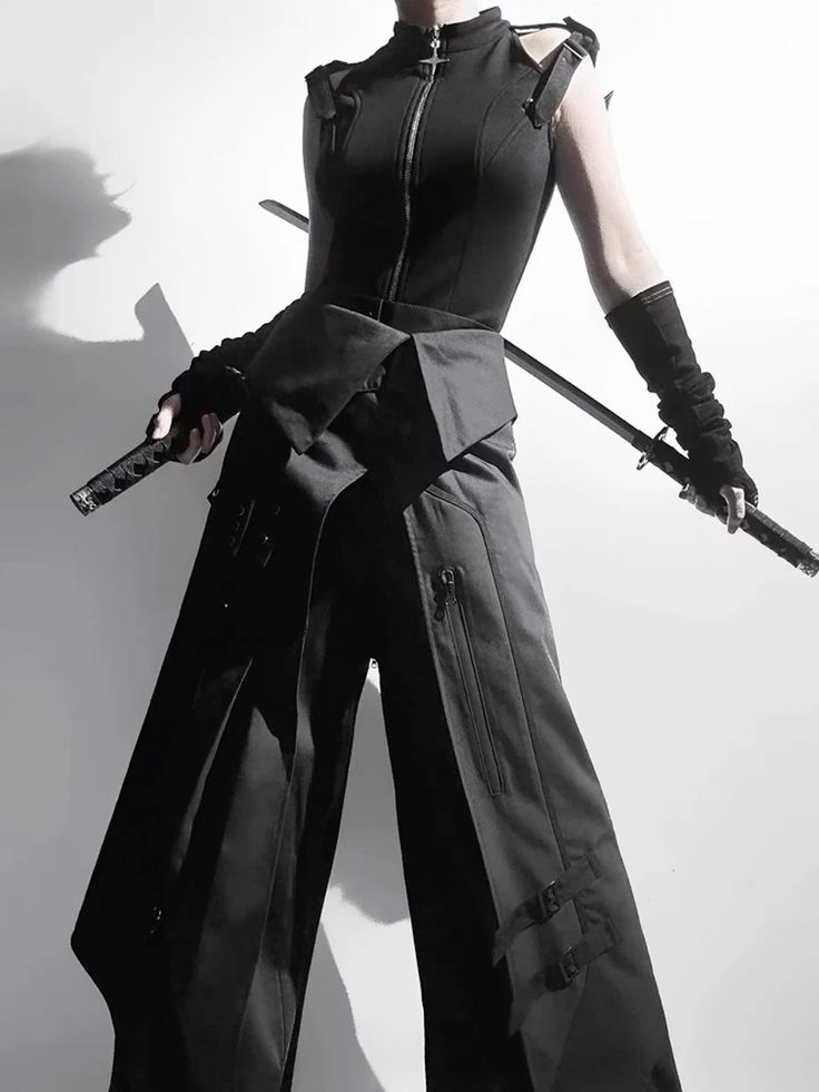 a woman poses with two swords in an outfit that features a sleeveless top, cargo pants, gloves, and techwear elements. the outfit is predominantly black, and it has tactical and goth influences, blending streetwear with functional design.