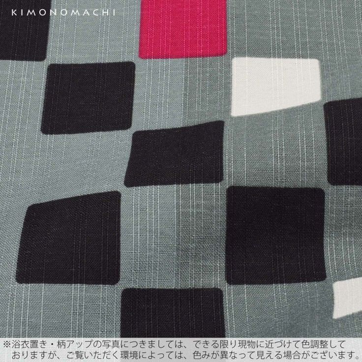 closeup shot of a patterned fabric featuring a geometric design. the fabric consists of a repeating pattern of black, white, and red squares set against a gray textured background. the squares are arranged in a gridlike fashion.