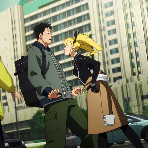 two cartoon characters are standing on a busy city street, seemingly in a confrontation. the man, dressed in green and black, looks surprised and frustrated. the woman, with blonde hair and a black and beige outfit, appears to be angrily confronting him. buildings and cars are visible in the background, indicating a bustling urban setting.