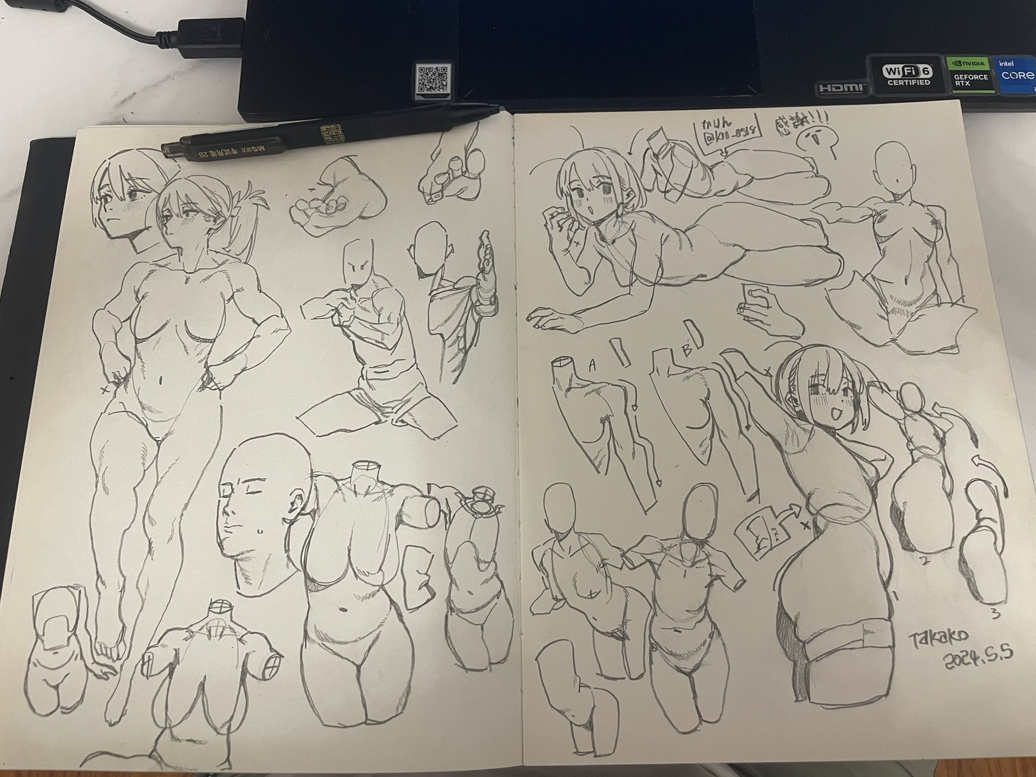 an open sketchbook is displayed, filled with pencil sketches of human figures in various poses, done in an animestyle. the drawings are a mix of full body studies, anatomical explorations, and character poses. the sketchbook lies on a surface with a pen and a laptop in the background.